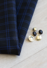 Textured wool in black tartan style with royal blue checks