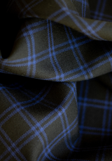 Textured wool in black tartan style with royal blue checks