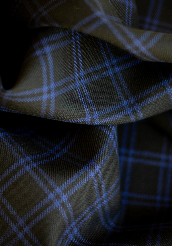 Textured wool in black tartan style with royal blue checks